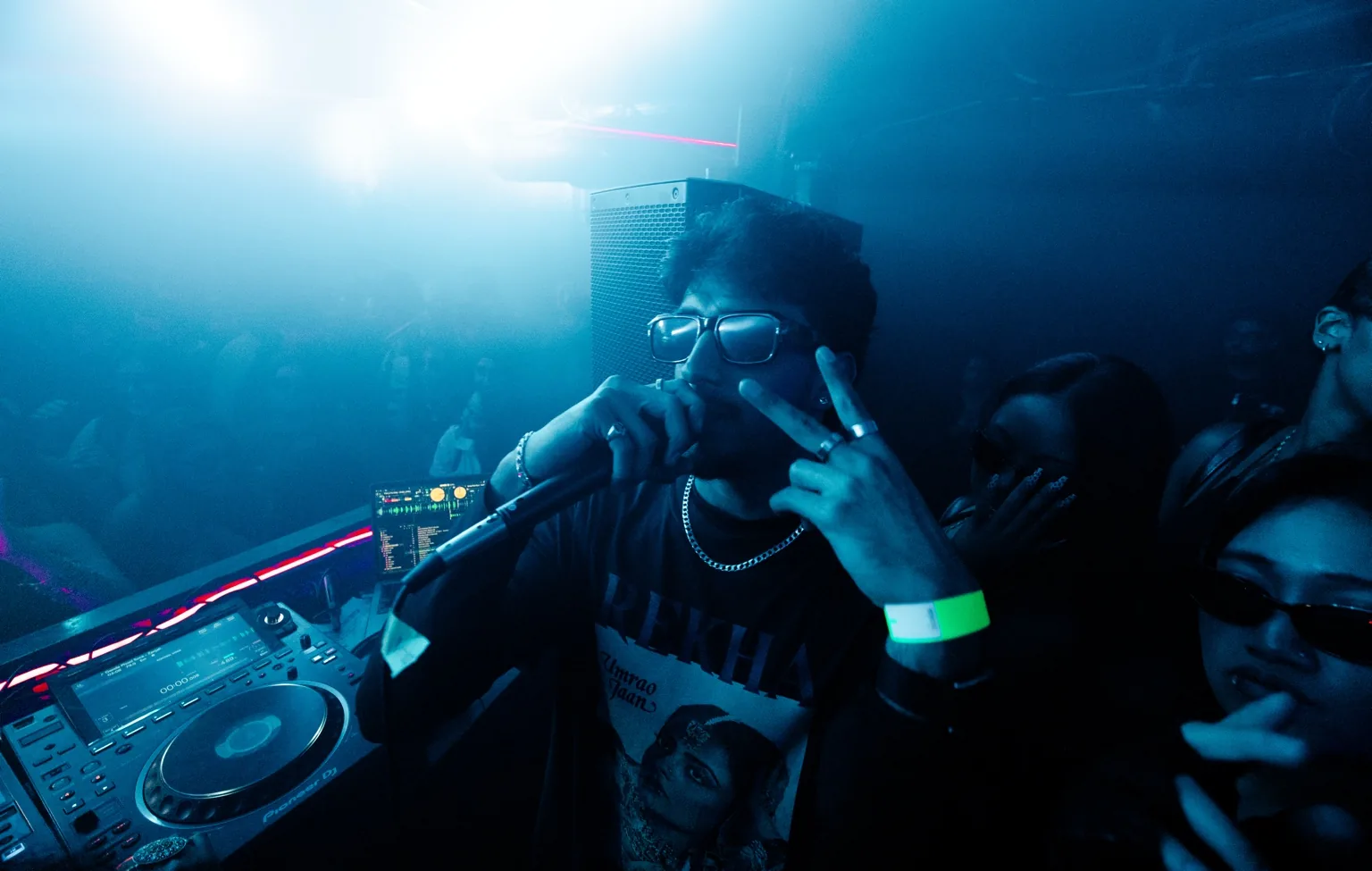 DJ performing beneath blue lighting at Project Kulture.