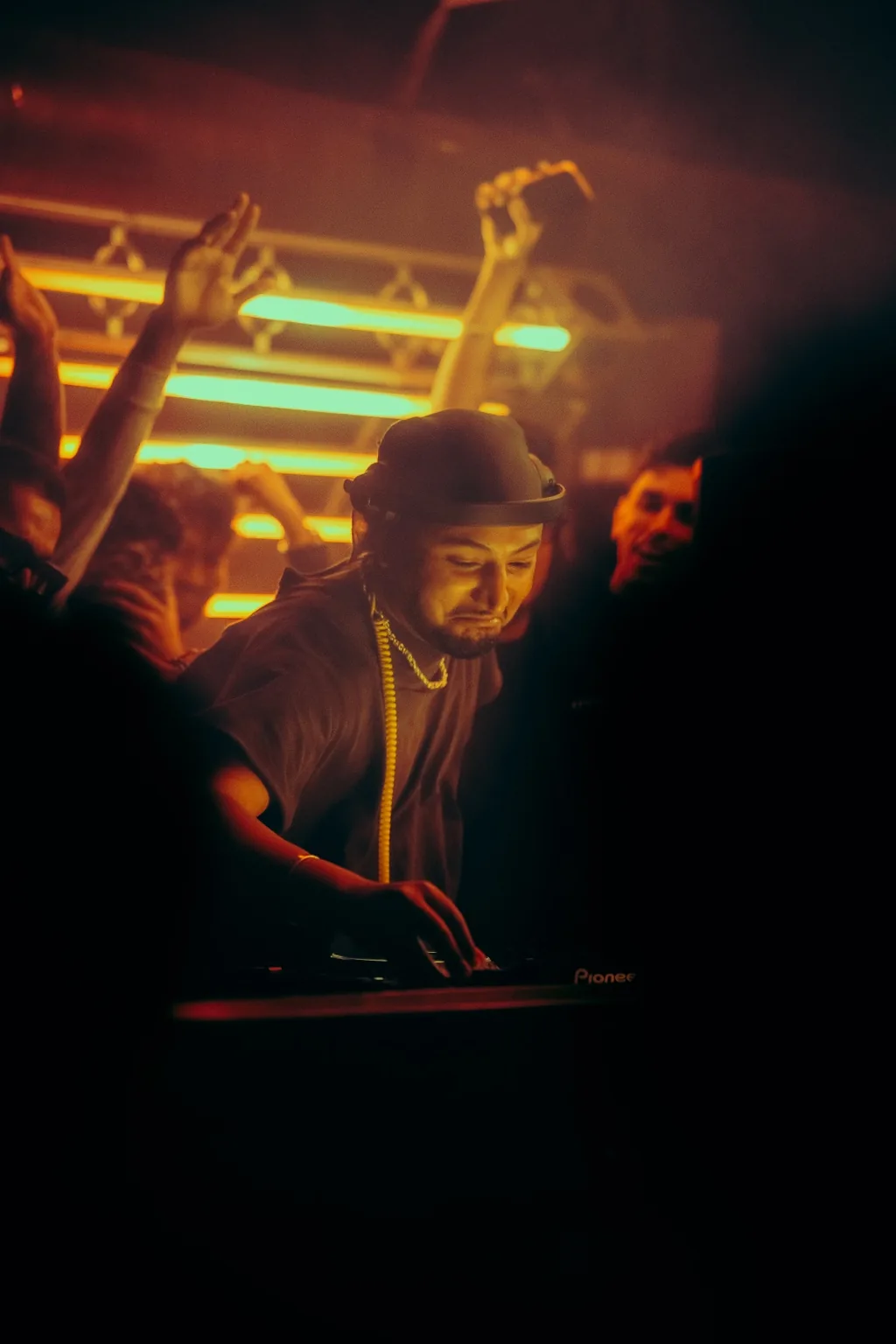 Guests dancing beneath warm light bars at Project Kulture.