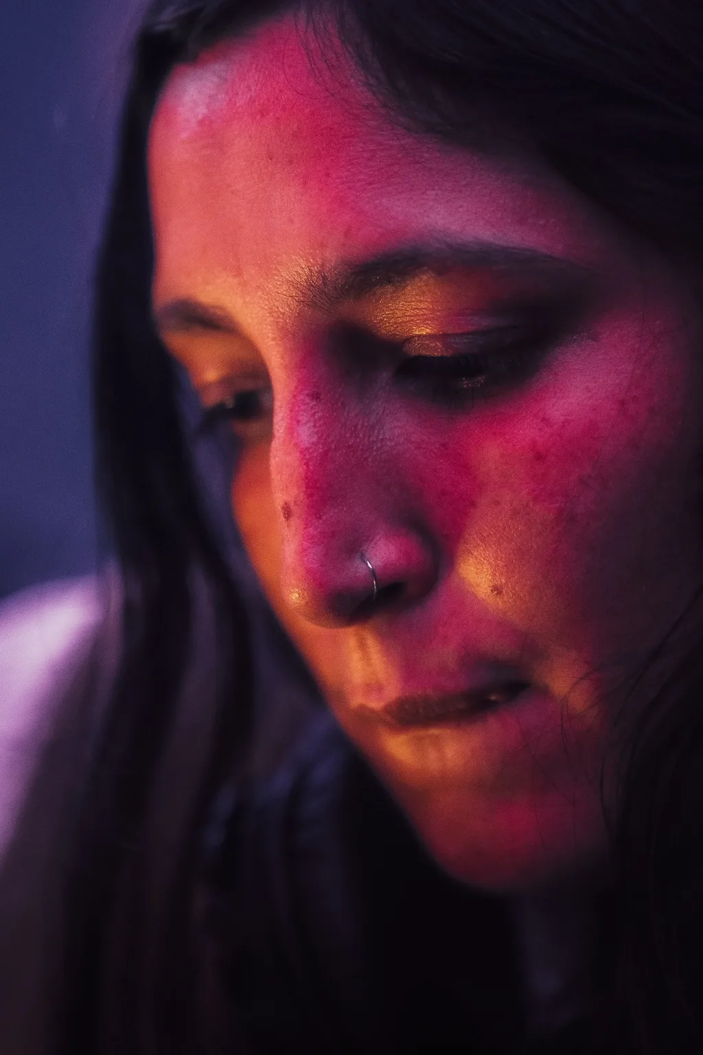 Close up of a guest under pink and blue lighting at Project Kulture.