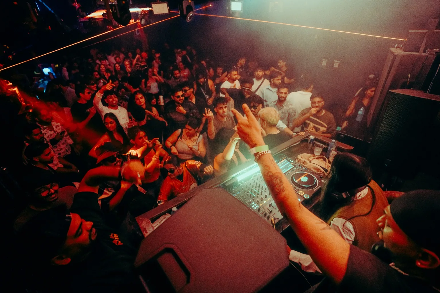 Crowd viewed from behind the DJ decks at Project Kulture.