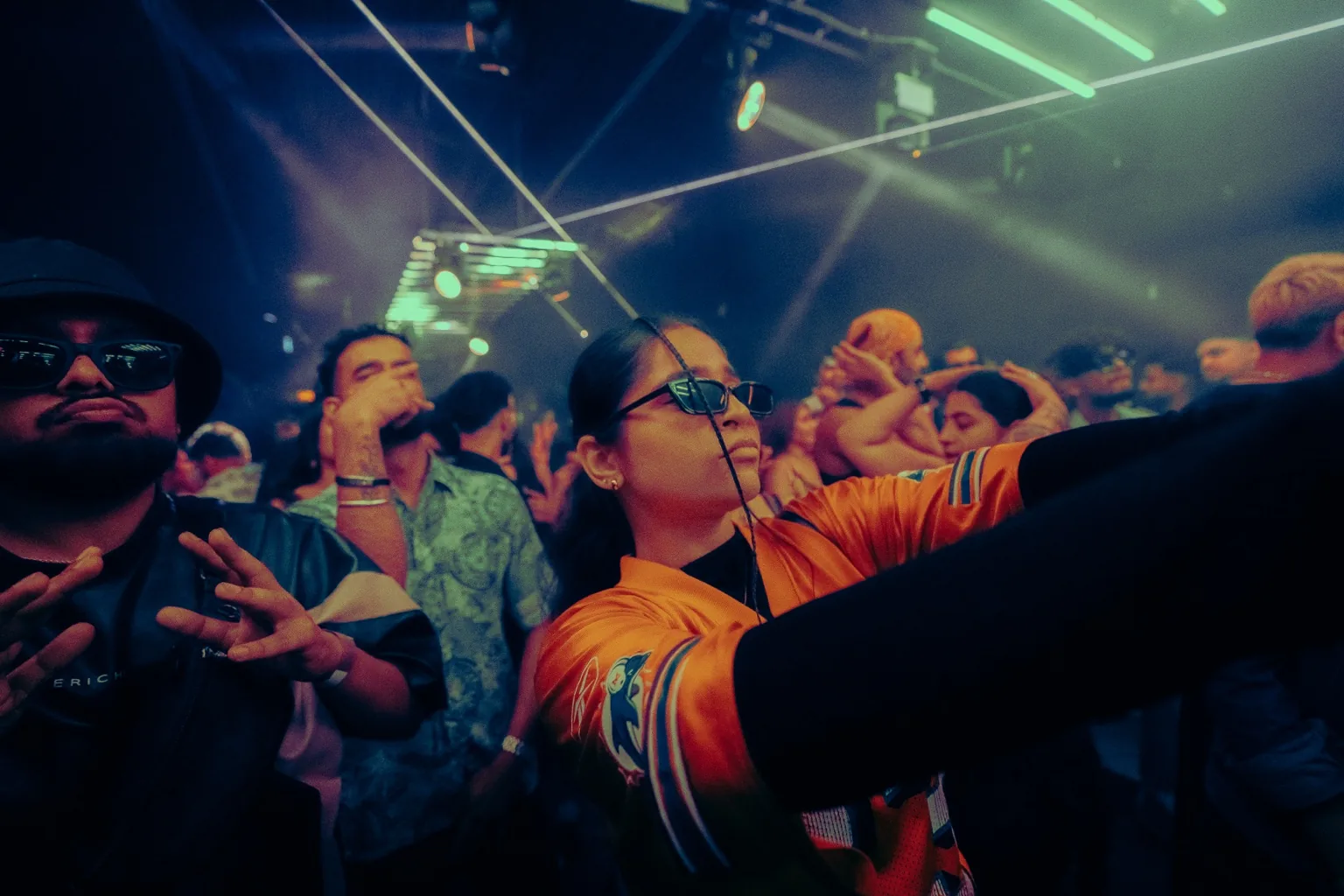 Guests smiling and dancing beside the DJ booth at Project Kulture.