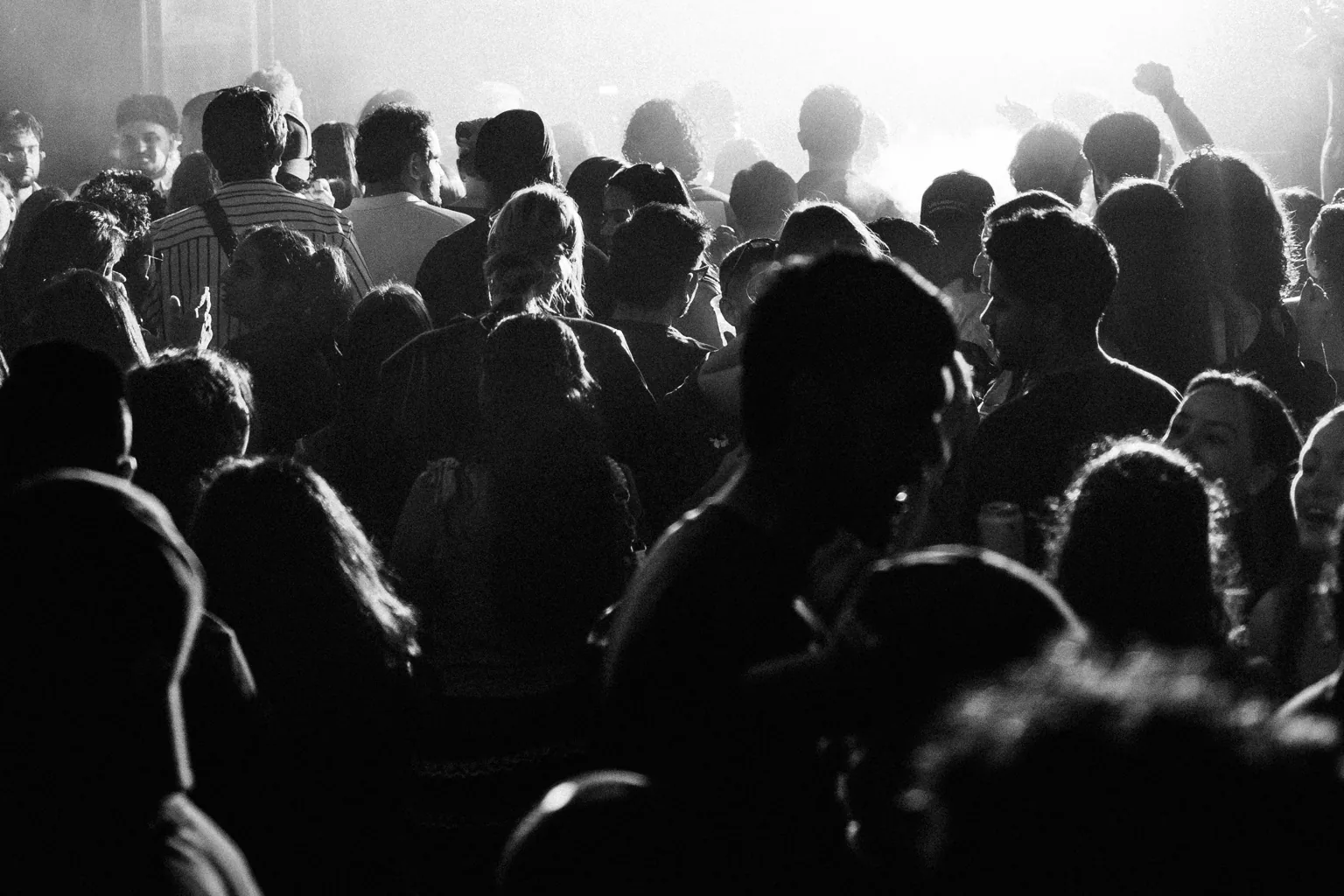 Black and white crowd scene in a hazy venue at Project Kulture.