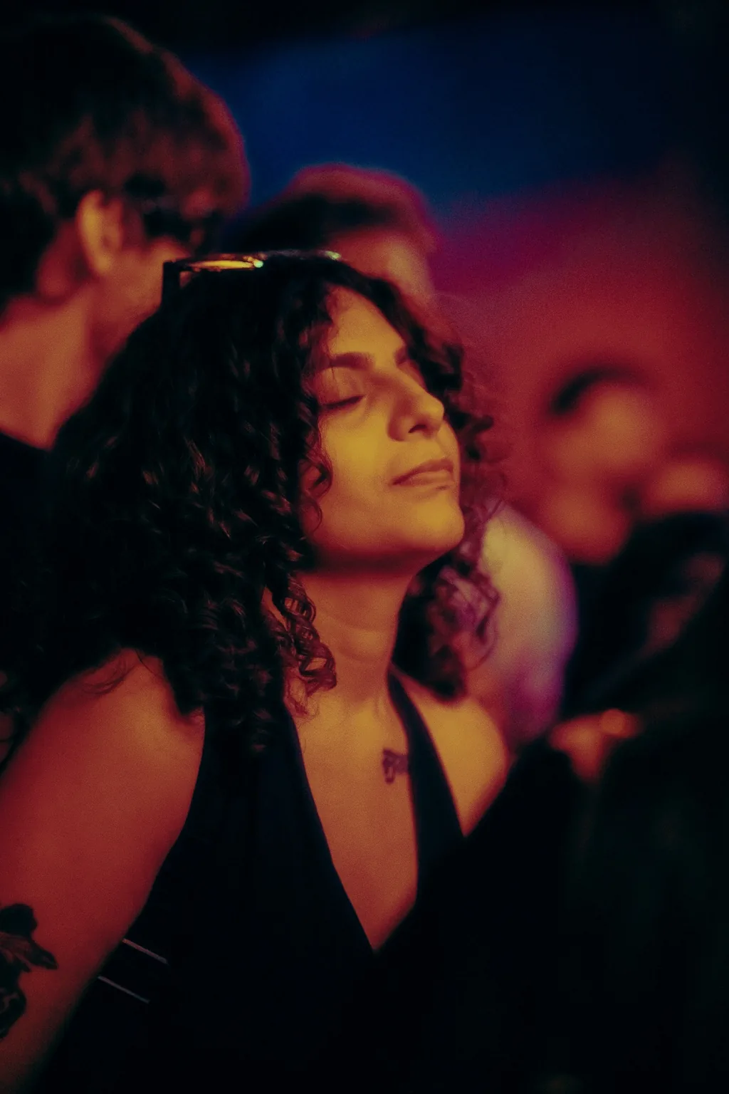 Guest enjoying the music in a softly lit crowd at Project Kulture.