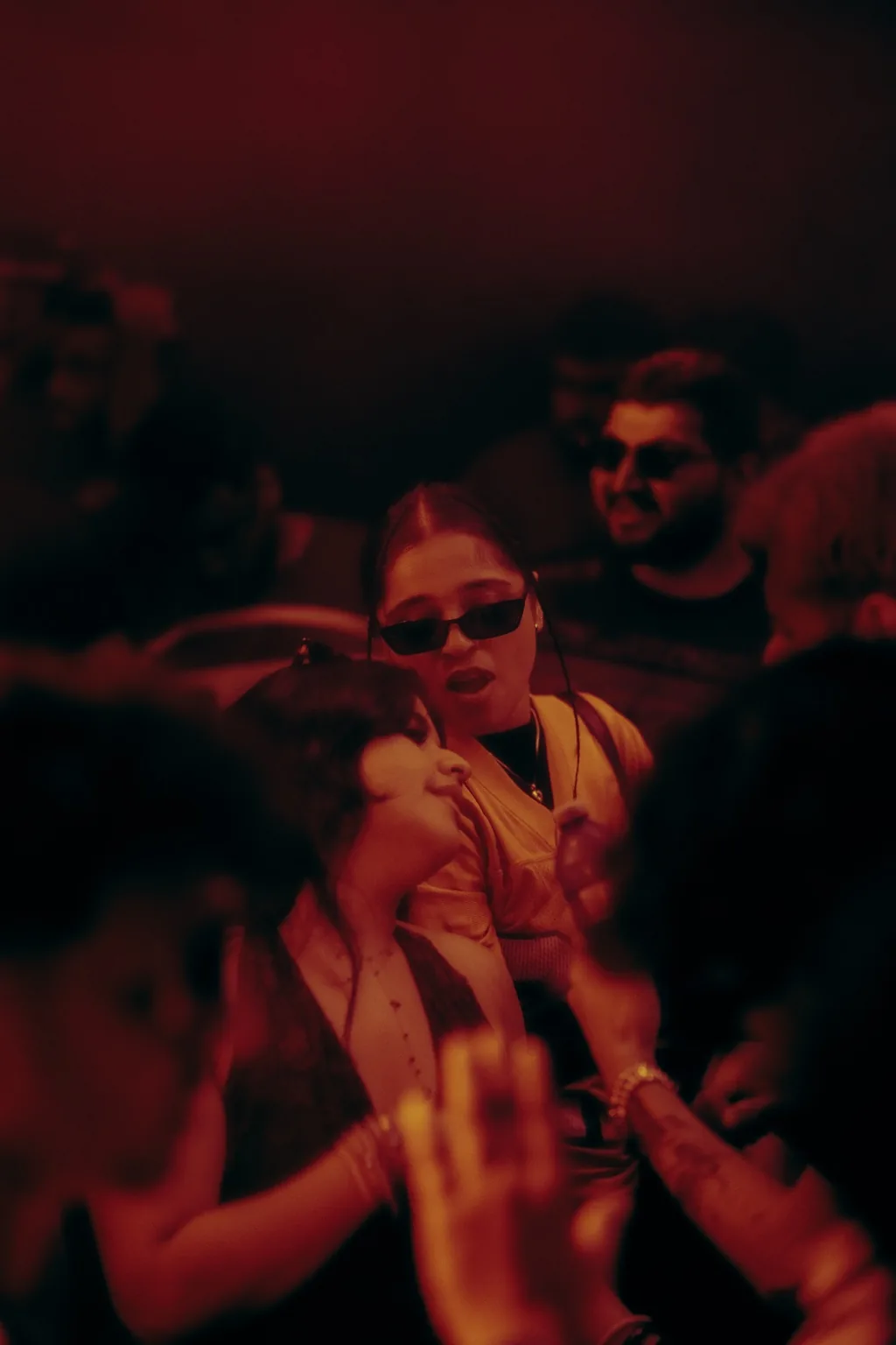 Guests enjoying the music under red lighting at Project Kulture.