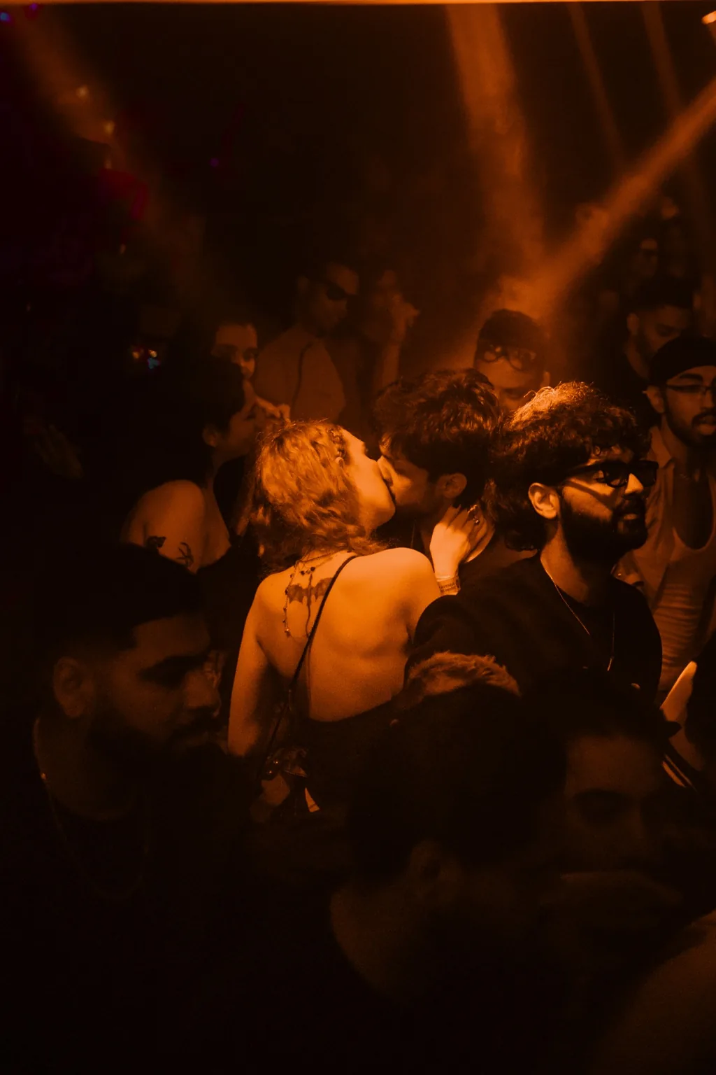 Crowd dancing under warm amber lighting at Project Kulture.