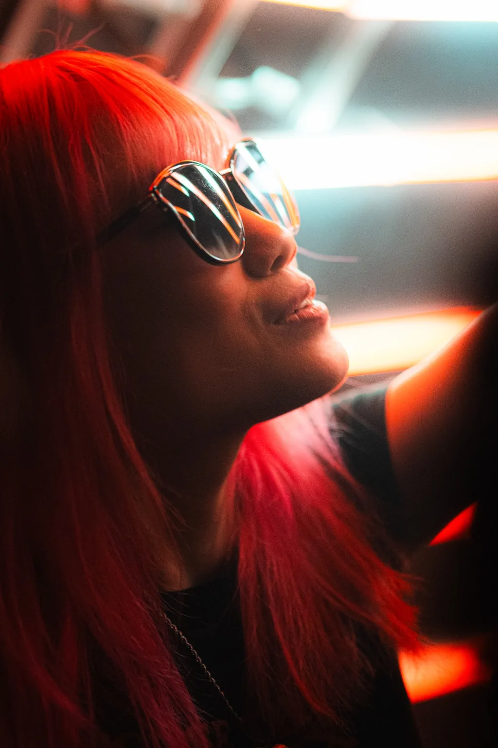 Guest wearing sunglasses beneath warm lighting at Project Kulture.