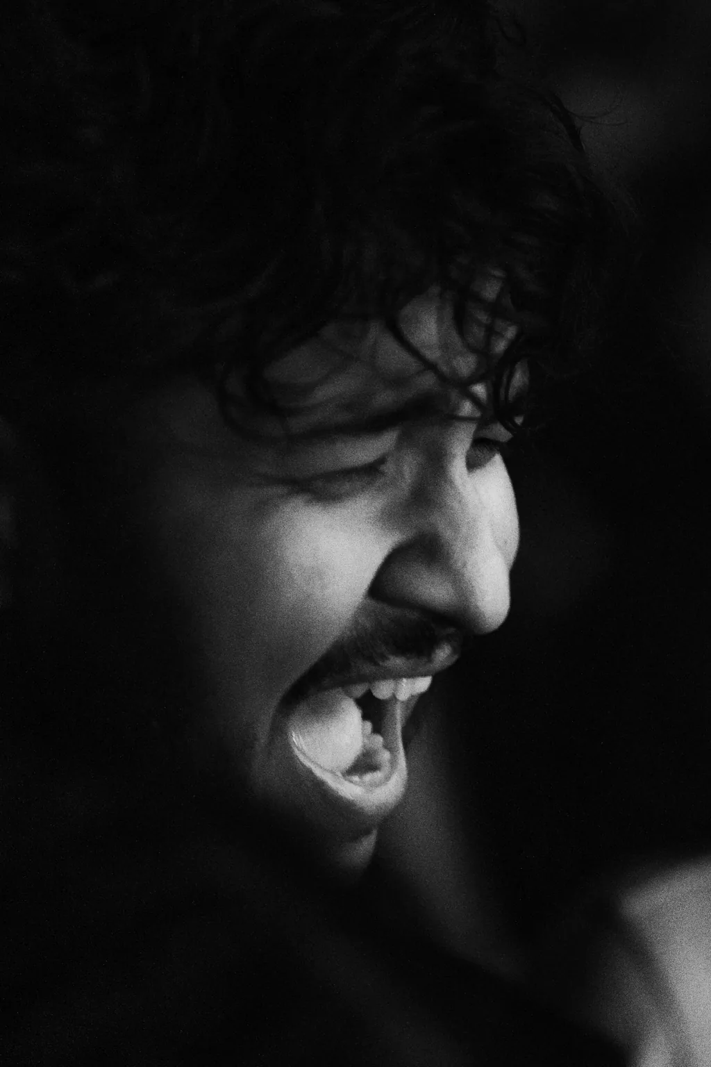 Black and white portrait of a guest singing along at Project Kulture.