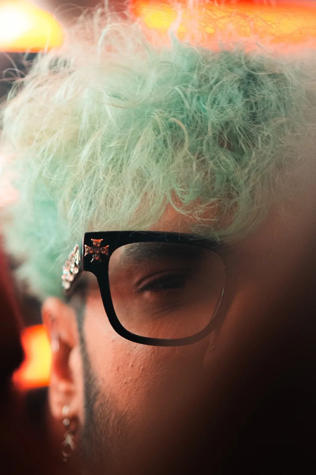 Close up of a guest with light hair and dark glasses at Project Kulture.