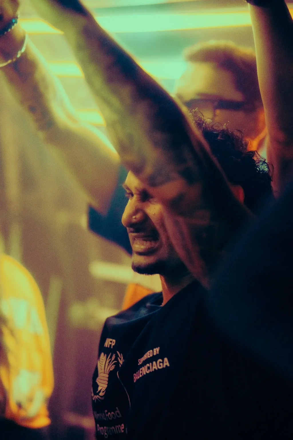 Guest smiling with both arms raised at Project Kulture.